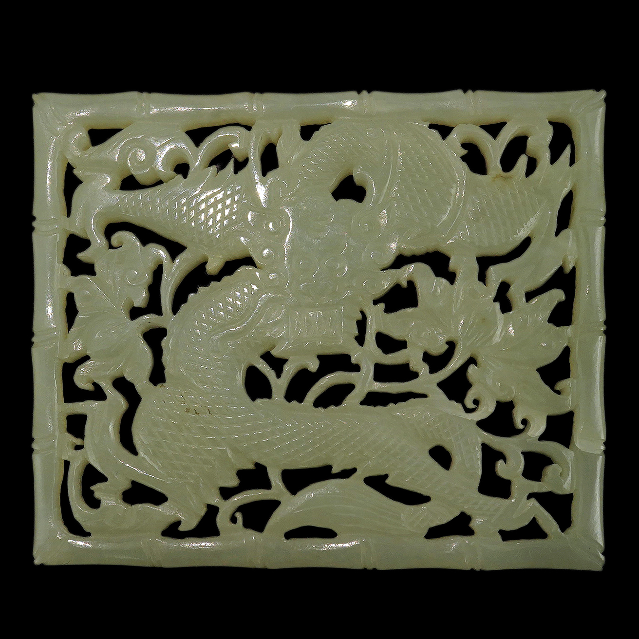 A Chinese pale celadon jade reticulated ‘dragon’ plaque, 19th century